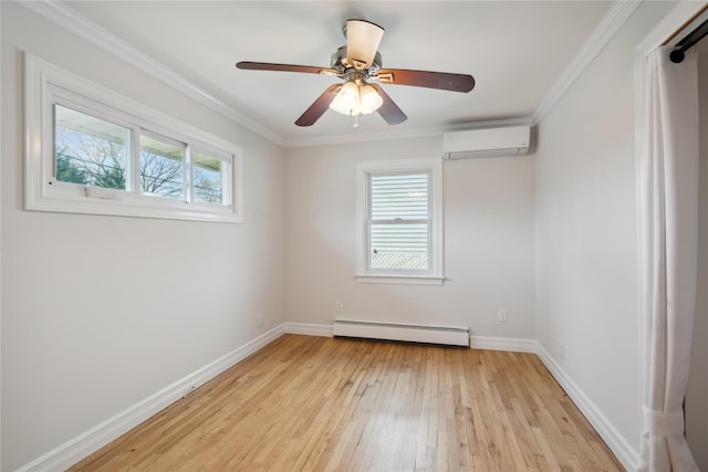 spare room featuring a baseboard heating unit, plenty of natural light, an AC wall unit, and light wood-style flooring