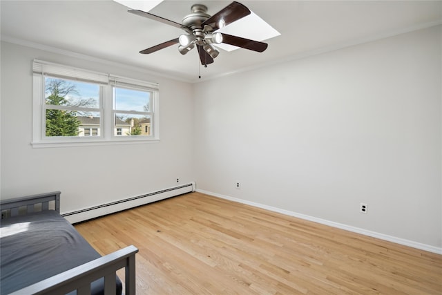 unfurnished bedroom with a ceiling fan, ornamental molding, light wood-style floors, baseboards, and a baseboard radiator