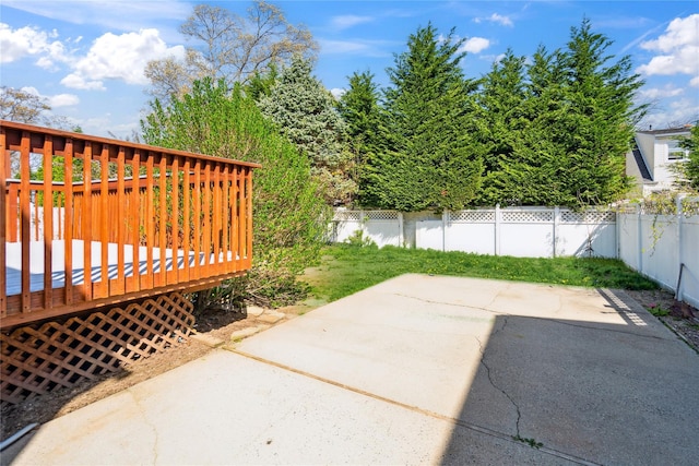 view of patio featuring a fenced backyard and a deck