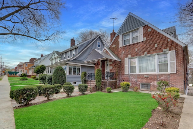view of front of house with brick siding and a front yard