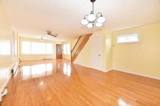 224-40 Fairbury Ave, Queens Village, NY 11428 - unfurnished living room featuring stairway, a healthy amount of sunlight, ceiling fan with notable chandelier, and light wood-type flooring
