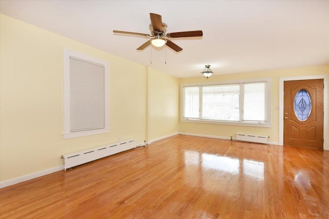 224-40 Fairbury Ave, Queens Village, NY 11428 - interior space featuring light wood-style floors, baseboards, a baseboard radiator, baseboard heating, and ceiling fan