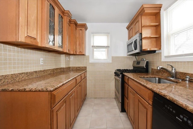 224-40 Fairbury Ave, Queens Village, NY 11428 - kitchen featuring brown cabinets, appliances with stainless steel finishes, dark stone counters, and a sink