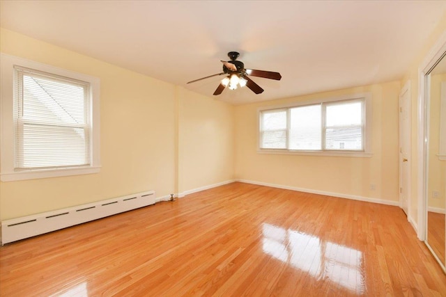 224-40 Fairbury Ave, Queens Village, NY 11428 - unfurnished bedroom featuring a baseboard radiator, light wood finished floors, baseboards, and ceiling fan