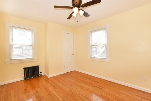 224-40 Fairbury Ave, Queens Village, NY 11428 - unfurnished room featuring radiator, baseboards, ceiling fan, and light wood-style flooring