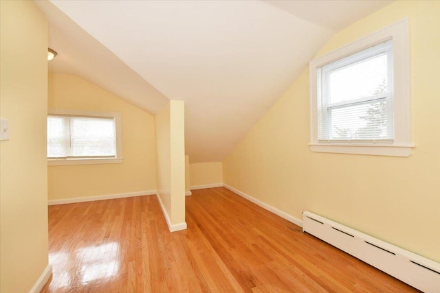 224-40 Fairbury Ave, Queens Village, NY 11428 - bonus room with vaulted ceiling, a healthy amount of sunlight, baseboard heating, and wood finished floors