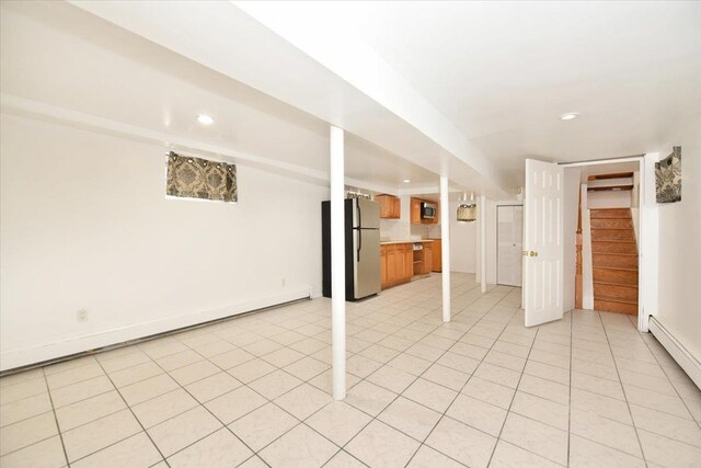 224-40 Fairbury Ave, Queens Village, NY 11428 - finished basement featuring a baseboard radiator, freestanding refrigerator, stairway, and recessed lighting