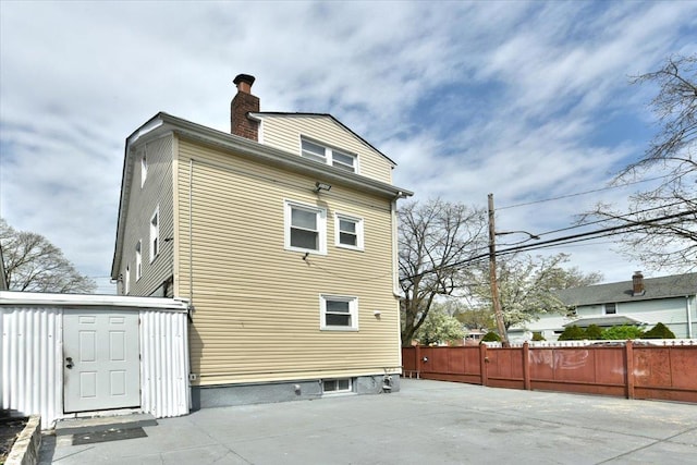 224-40 Fairbury Ave, Queens Village, NY 11428 - back of property featuring a chimney and fence