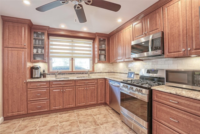 176 Kearsing Pkwy, Monsey, NY 10952 - kitchen featuring stainless steel appliances, a ceiling fan, decorative backsplash, brown cabinetry, and recessed lighting