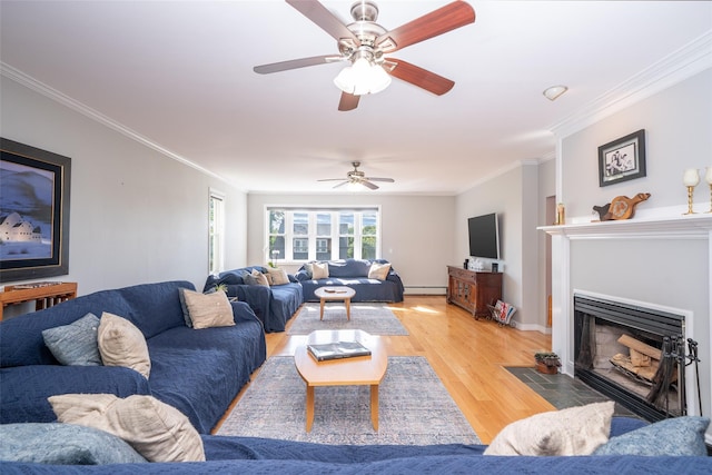 116 Oakland Ave, Tuckahoe, NY 10707 - living area featuring baseboard heating, crown molding, light wood finished floors, a ceiling fan, and a fireplace with flush hearth