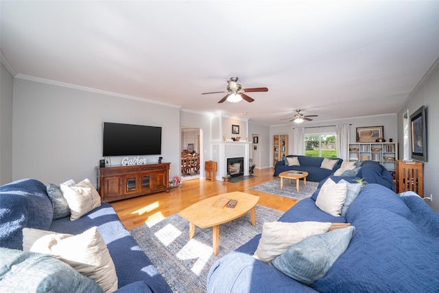 116 Oakland Ave, Tuckahoe, NY 10707 - living room featuring light wood-style floors, a ceiling fan, crown molding, and a fireplace with flush hearth