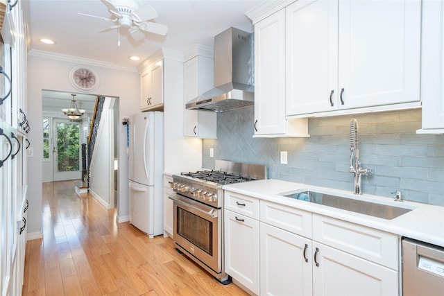 116 Oakland Ave, Tuckahoe, NY 10707 - kitchen featuring wall chimney range hood, appliances with stainless steel finishes, a sink, white cabinets, and light countertops