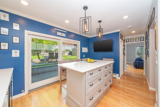 116 Oakland Ave, Tuckahoe, NY 10707 - kitchen with white cabinetry, light countertops, a breakfast bar area, light wood finished floors, and a baseboard heating unit