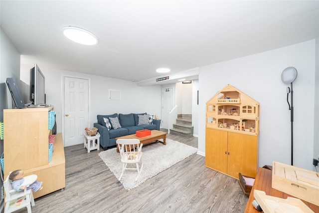 116 Oakland Ave, Tuckahoe, NY 10707 - living room featuring light wood-style floors, stairway, and baseboards