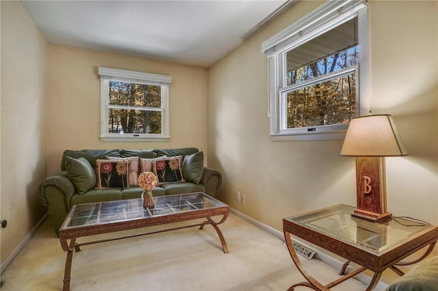 sitting room featuring baseboards, a healthy amount of sunlight, and carpet flooring