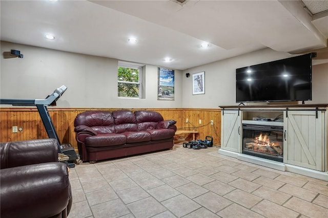 living area featuring a wainscoted wall, wood walls, recessed lighting, and light tile patterned floors