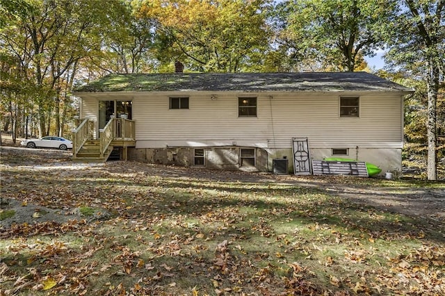 back of property featuring a chimney and central air condition unit