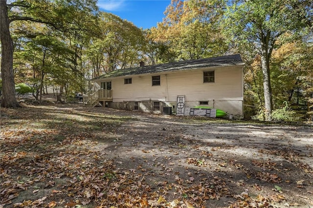 back of house with central AC unit