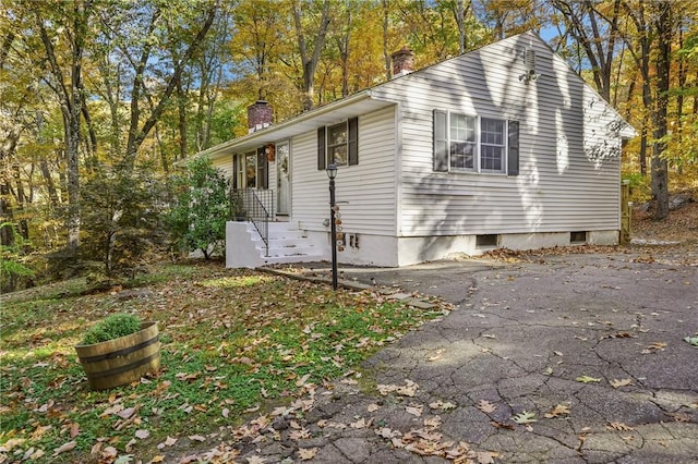 view of property exterior featuring a chimney