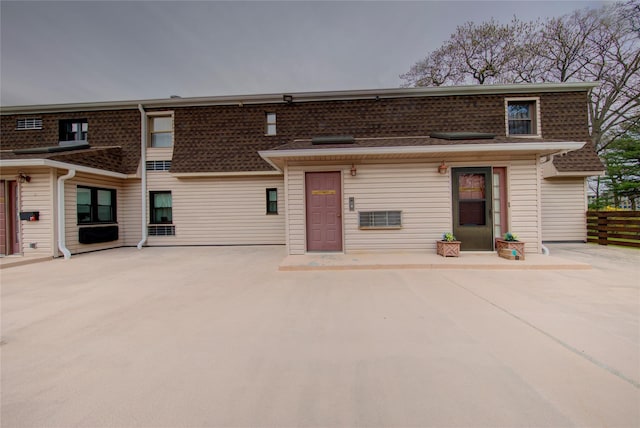 1337 Broadway Unit C22, Hewlett, NY 11557 - view of front of home featuring roof with shingles, fence, and a patio