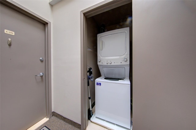 1337 Broadway Unit C22, Hewlett, NY 11557 - washroom featuring baseboards, stacked washer and clothes dryer, laundry area, and light colored carpet