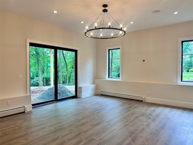 9 Ogrady Ct, Orangeburg, NY 10962 - spare room featuring baseboard heating, a chandelier, wood finished floors, recessed lighting, and baseboards