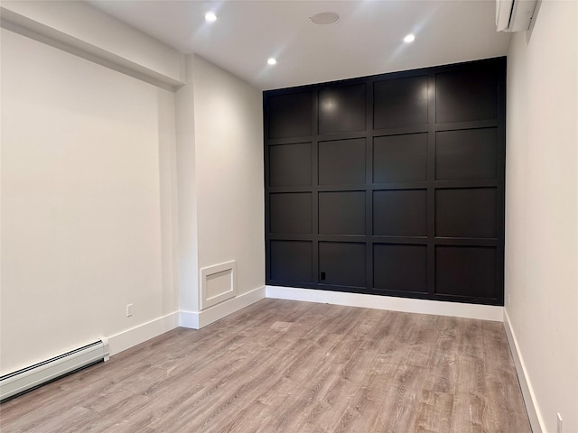 9 Ogrady Ct, Orangeburg, NY 10962 - unfurnished room with a decorative wall, baseboard heating, light wood finished floors, baseboards, and a wall mounted AC