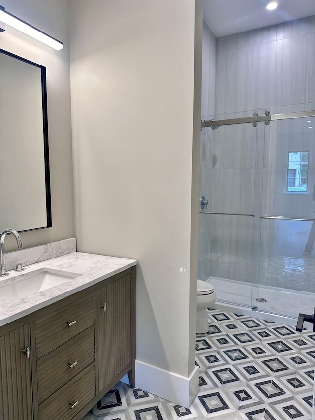 9 Ogrady Ct, Orangeburg, NY 10962 - bathroom featuring vanity, toilet, baseboards, and a stall shower