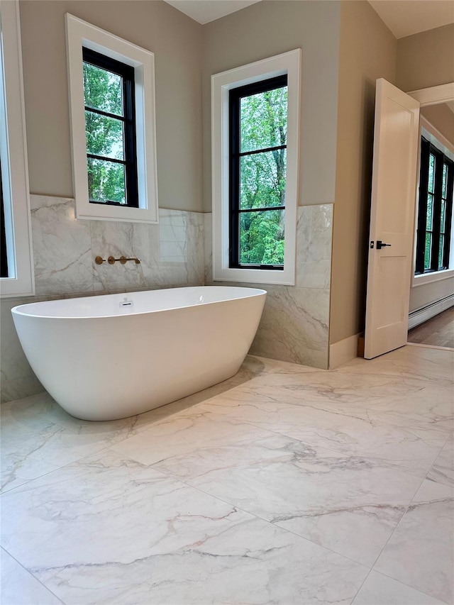 9 Ogrady Ct, Orangeburg, NY 10962 - bathroom with a freestanding bath, wainscoting, tile walls, marble finish flooring, and a baseboard heating unit
