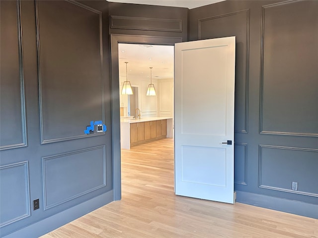9 Ogrady Ct, Orangeburg, NY 10962 - hallway with a decorative wall, light wood-style flooring, and a sink