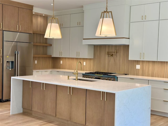 9 Ogrady Ct, Orangeburg, NY 10962 - kitchen with high end refrigerator, a sink, light wood-style floors, open shelves, and light stone counters