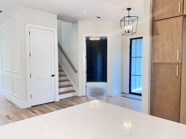 9 Ogrady Ct, Orangeburg, NY 10962 - foyer entrance with light wood-style floors, a chandelier, stairway, and baseboards