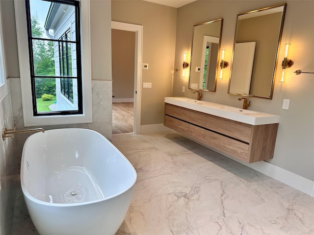 9 Ogrady Ct, Orangeburg, NY 10962 - bathroom with marble finish floors, double vanity, a freestanding bath, and baseboards