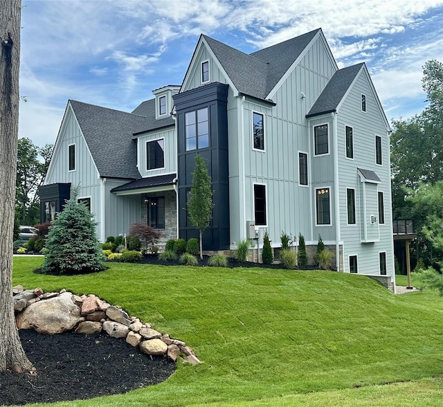 9 Ogrady Ct, Orangeburg, NY 10962 - view of front facade featuring board and batten siding, a shingled roof, and a front lawn