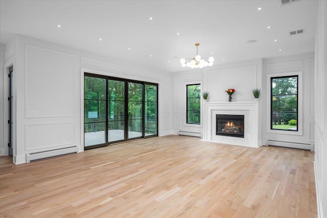 9 Ogrady Ct, Orangeburg, NY 10962 - unfurnished living room featuring a decorative wall, baseboard heating, healthy amount of natural light, light wood-style flooring, and recessed lighting