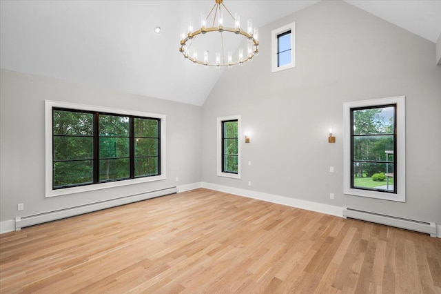 9 Ogrady Ct, Orangeburg, NY 10962 - empty room featuring baseboard heating, a chandelier, high vaulted ceiling, and wood finished floors