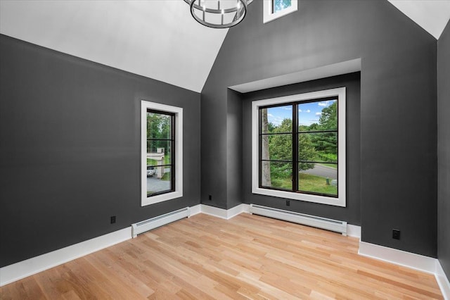 9 Ogrady Ct, Orangeburg, NY 10962 - unfurnished room featuring a baseboard radiator, light wood-type flooring, high vaulted ceiling, and a chandelier