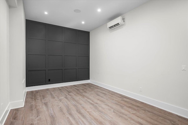 9 Ogrady Ct, Orangeburg, NY 10962 - spare room with a decorative wall, a wall mounted air conditioner, light wood-type flooring, and recessed lighting