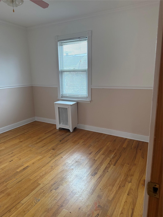 93-30 246th St, Bellerose Terrace, NY 11001 - spare room featuring a ceiling fan, baseboards, crown molding, and light wood-type flooring