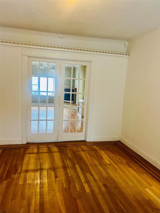 93-30 246th St, Bellerose Terrace, NY 11001 - doorway featuring wood-type flooring, baseboards, crown molding, and a textured ceiling