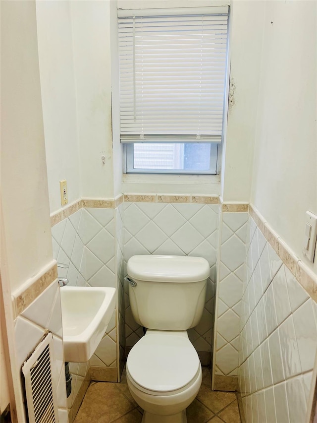 93-30 246th St, Bellerose Terrace, NY 11001 - bathroom with tile walls, tile patterned floors, a wainscoted wall, and toilet