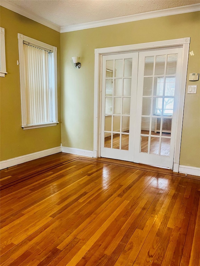 93-30 246th St, Bellerose Terrace, NY 11001 - empty room with hardwood / wood-style flooring, baseboards, a textured ceiling, and crown molding