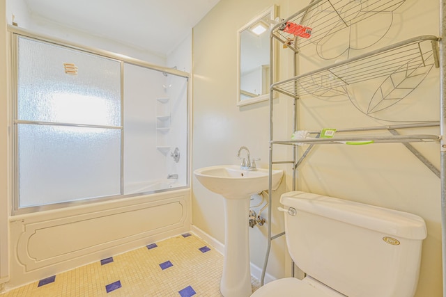 full bath with enclosed tub / shower combo, toilet, and baseboards
