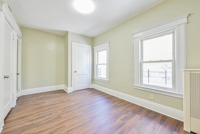 unfurnished bedroom with baseboards and wood finished floors