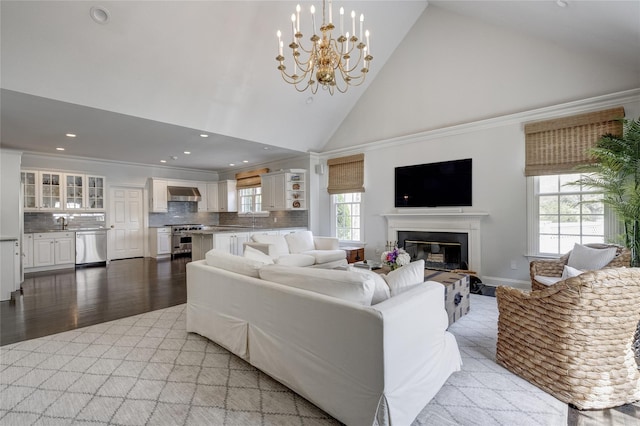 11 Morgan Ln, Locust Valley, NY 11560 - living area featuring high vaulted ceiling, recessed lighting, light wood-style flooring, a glass covered fireplace, and a chandelier