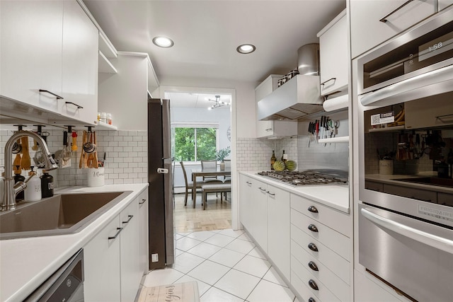 372 Central Park Ave Unit 1C, Scarsdale, NY 10583 - kitchen with a warming drawer, open shelves, appliances with stainless steel finishes, light countertops, and white cabinetry