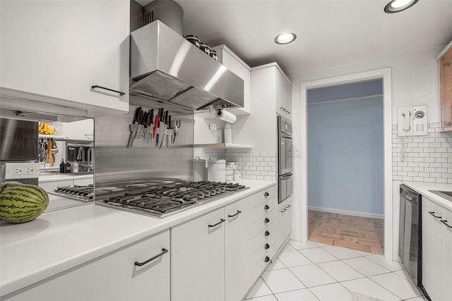 372 Central Park Ave Unit 1C, Scarsdale, NY 10583 - kitchen featuring wall chimney exhaust hood, stainless steel appliances, light countertops, white cabinetry, and decorative backsplash