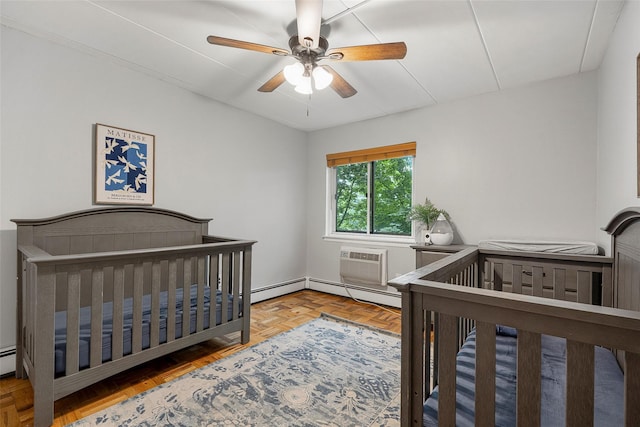 372 Central Park Ave Unit 1C, Scarsdale, NY 10583 - bedroom featuring a baseboard heating unit, a wall unit AC, a ceiling fan, and a crib