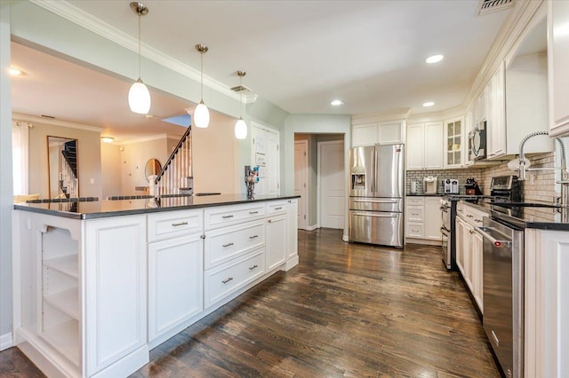 2814 River Ave, Oceanside, NY 11572 - kitchen with crown molding, white cabinets, dark countertops, appliances with stainless steel finishes, and dark wood-style floors