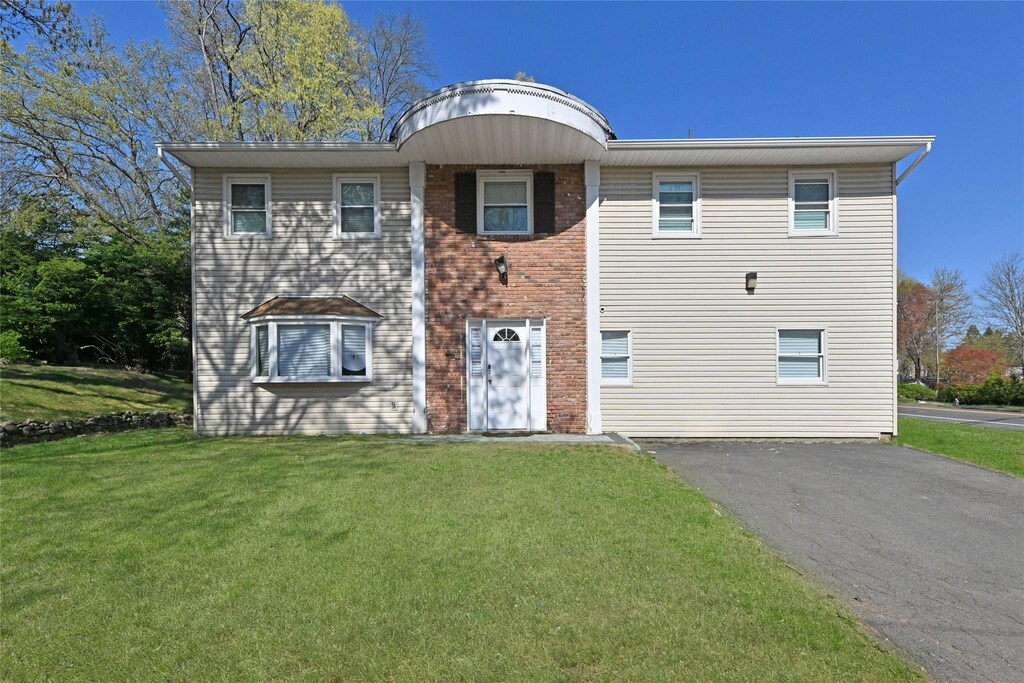 1 Bedford Ct, Spring Valley, NY 10977 - view of front of property featuring a front yard, driveway, and brick siding